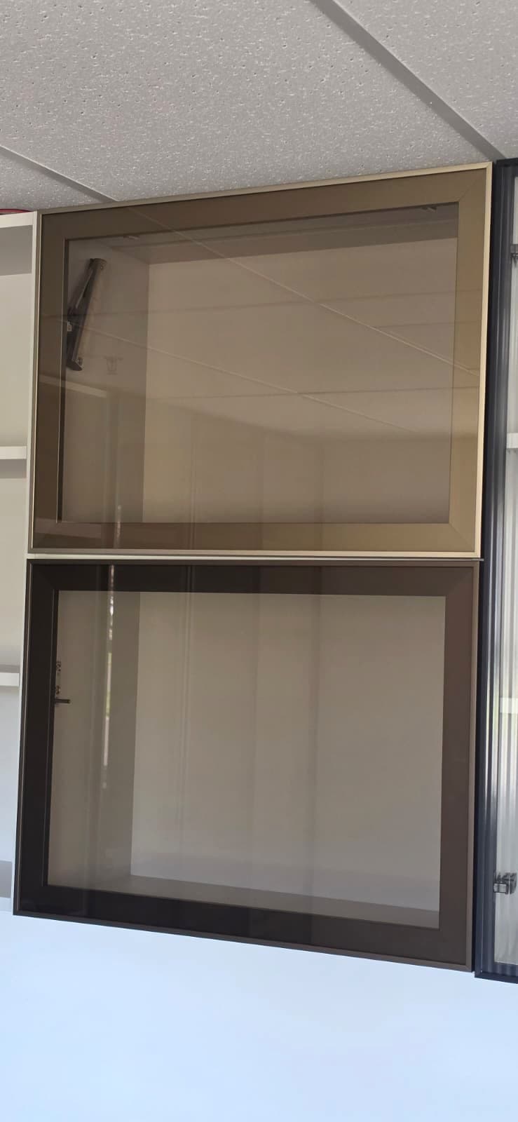 Installed champagne and dark aluminum frame doors with bronze tempered glass